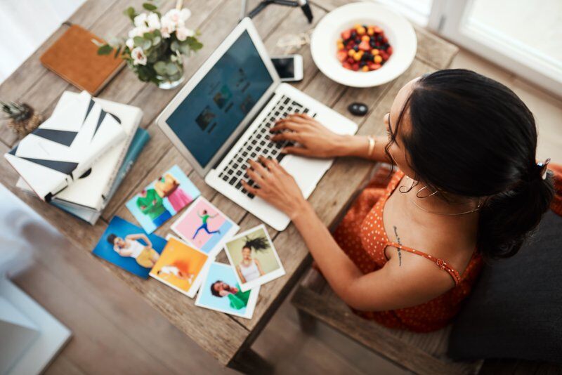 High angle shot of an unrecognizable businesswoman sitting in her home office and blogging from her laptop